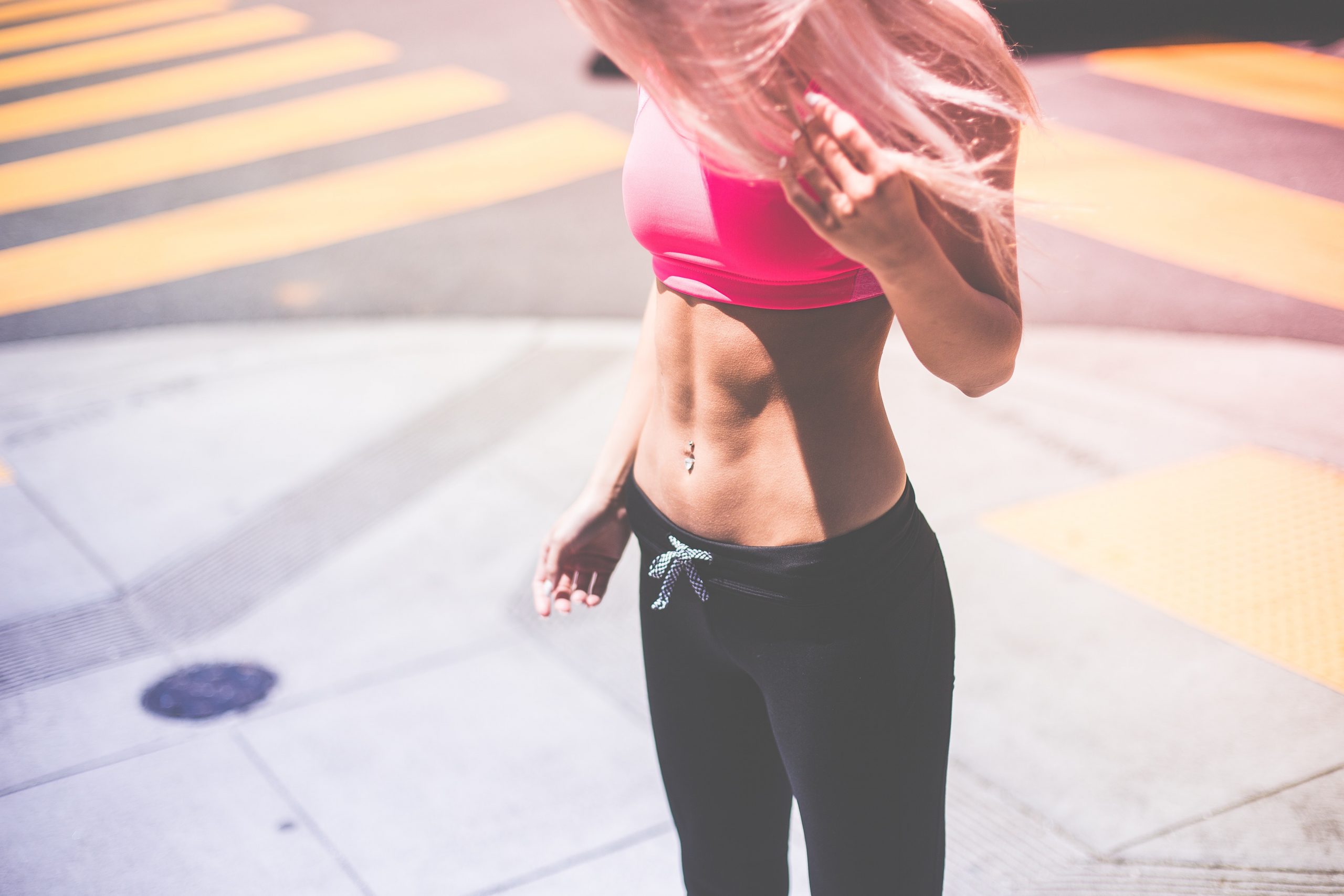 woman-wearing-pink-sports-bra-and-black-draw-string-pants-196640
